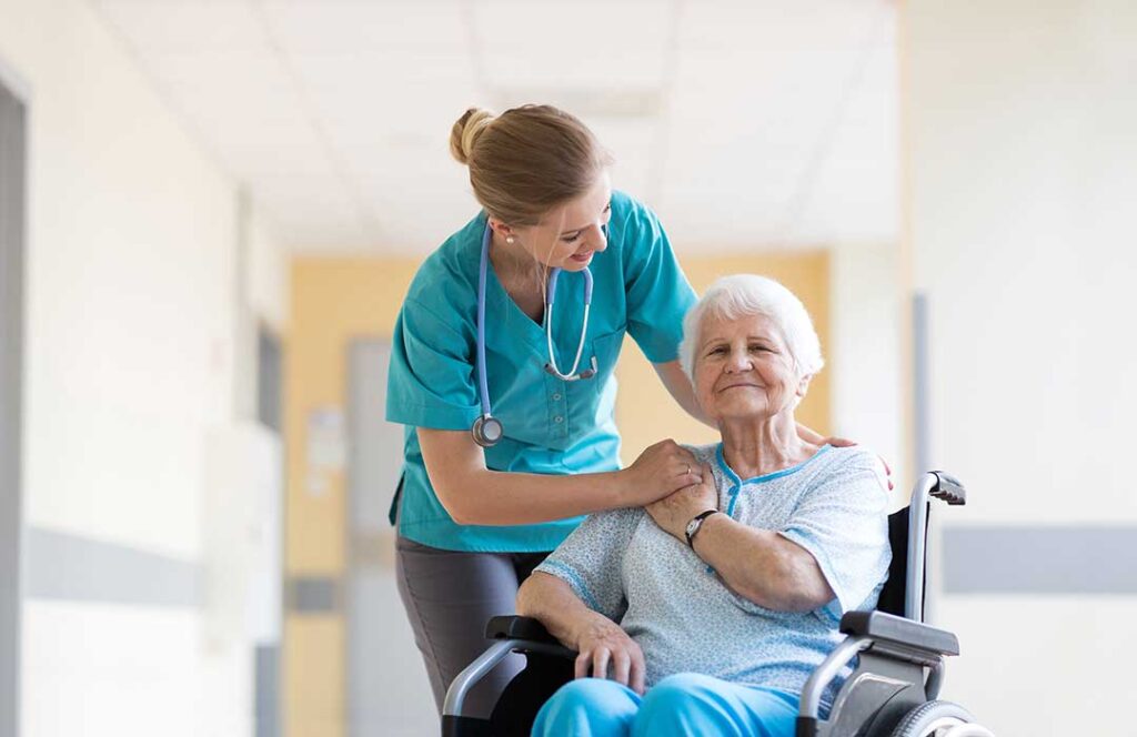 Older adult and family member reviewing care notes together at a kitchen table.